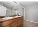 Bathroom featuring double sinks, tile floor, and glass enclosed shower at 17148 Waterhouse Cir # A, Parker, CO 80134