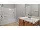 Bathroom features a combined tub and shower with a single sink vanity and a white door at 17148 Waterhouse Cir # A, Parker, CO 80134