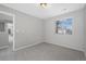 This bedroom has neutral paint, soft carpeting, and a window offering ample natural light at 17148 Waterhouse Cir # A, Parker, CO 80134