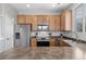 Bright kitchen featuring wooden cabinets, stainless steel appliances, and ample counter space at 17148 Waterhouse Cir # A, Parker, CO 80134