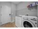 Functional laundry room with a washer, dryer, shelving for storage, and a utility sink at 17148 Waterhouse Cir # A, Parker, CO 80134