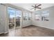 Bright living room with access to a patio, featuring hardwood floors and a ceiling fan at 17148 Waterhouse Cir # A, Parker, CO 80134