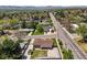 An aerial view shows a neighborhood with tidy lawns and sidewalks at 2704 S Ames Way, Denver, CO 80227