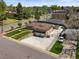 Aerial view of a home with a two-car garage and a manicured front yard at 2704 S Ames Way, Denver, CO 80227