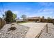 Wide shot of a backyard featuring a patio, shed, and yard with decorative rocks at 2704 S Ames Way, Denver, CO 80227