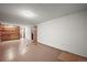 View of the basement with built in shelves and a doorway to the stairs at 2704 S Ames Way, Denver, CO 80227
