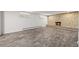 Finished basement with stone fireplace and wood-look flooring at 2704 S Ames Way, Denver, CO 80227