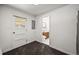 A view from a hallway to the bathroom with oak vanity and white toilet at 2704 S Ames Way, Denver, CO 80227