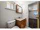 Bright bathroom featuring an oak vanity, medicine cabinet, and tiled floor at 2704 S Ames Way, Denver, CO 80227