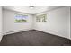 Bedroom with neutral walls, carpet, and two bright windows at 2704 S Ames Way, Denver, CO 80227