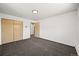 Spacious bedroom with neutral walls, plush carpeting, closet, and access to the hallway at 2704 S Ames Way, Denver, CO 80227