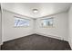 Bedroom with neutral walls, carpet, and two bright windows at 2704 S Ames Way, Denver, CO 80227