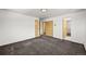 Neutral bedroom with two closets, carpet, and access to other rooms at 2704 S Ames Way, Denver, CO 80227