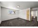 A spacious bedroom with neutral walls, carpet, and a bright window at 2704 S Ames Way, Denver, CO 80227