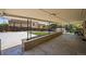 A large covered patio with concrete flooring and access to the backyard at 2704 S Ames Way, Denver, CO 80227