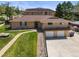 Charming ranch-style home with a brick facade, manicured lawn, and convenient two-car garage at 2704 S Ames Way, Denver, CO 80227