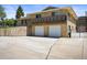 Two-story home with brick exterior, two-car garage, balcony and gated access at 2704 S Ames Way, Denver, CO 80227