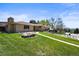 Charming brick home featuring a well-manicured lawn and walkway leading to the entrance at 2704 S Ames Way, Denver, CO 80227