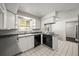 Functional kitchen with white cabinetry, sleek countertops, and modern appliances, perfect for culinary adventures at 2704 S Ames Way, Denver, CO 80227