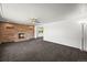 Spacious living room with a brick fireplace and neutral-toned carpeting, ready for personalization at 2704 S Ames Way, Denver, CO 80227