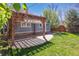 Beautiful backyard with wooden pergola, patio, and lush green lawn at 5101 Meade St, Denver, CO 80221