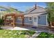 Backyard featuring a charming pergola-covered patio area and a spacious lawn at 5101 Meade St, Denver, CO 80221