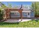 Inviting backyard featuring a stone patio with pergola and a well-manicured lawn at 5101 Meade St, Denver, CO 80221