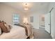 Inviting bedroom with neutral tones, soft carpet, and a view to the hallway entrance at 5101 Meade St, Denver, CO 80221