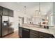Open kitchen with granite countertops, stainless steel appliances, and a breakfast bar at 5101 Meade St, Denver, CO 80221