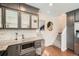 Modern kitchen featuring granite countertops, stainless steel microwave, and hexagon tile backsplash at 5101 Meade St, Denver, CO 80221