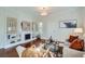 Bright living room featuring hardwood floors, a fireplace, and stylish decor at 5101 Meade St, Denver, CO 80221