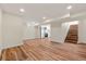 Finished basement with wood flooring leads to stairs and a view of the kitchen at 1073 Galena St, Aurora, CO 80010