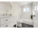 Elegant bathroom featuring marble tiling, modern vanity, and a luxurious shower-tub at 1073 Galena St, Aurora, CO 80010