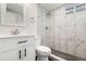 Upgraded bathroom featuring marble tiling, a modern vanity, and a rainfall shower at 1073 Galena St, Aurora, CO 80010