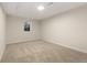 Empty bedroom features neutral carpeting and a window for natural light at 1073 Galena St, Aurora, CO 80010