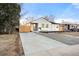 View of the home featuring a long driveway and modern exterior upgrades at 1073 Galena St, Aurora, CO 80010