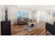 Well lit living room with hard wood floors and neutral decor at 1073 Galena St, Aurora, CO 80010