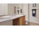 Well-lit bathroom with a single sink vanity, neutral walls, and decor at 11975 Riverstone Cir # 9E, Henderson, CO 80640