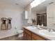 Bright bathroom featuring a double sink vanity, neutral wall color, and walk-in shower at 11975 Riverstone Cir # 9E, Henderson, CO 80640