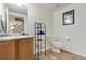 Simple bathroom featuring neutral-colored walls and flooring, including a rack for towels at 11975 Riverstone Cir # 9E, Henderson, CO 80640