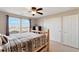 Well-lit bedroom features wood bed frame, closet and a large window with a view at 11975 Riverstone Cir # 9E, Henderson, CO 80640