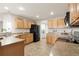 Well-lit kitchen showcasing wooden cabinets, countertops, and modern black appliances at 11975 Riverstone Cir # 9E, Henderson, CO 80640