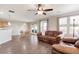 Bright living room featuring hardwood floors, fan, and a comfortable leather sofa at 11975 Riverstone Cir # 9E, Henderson, CO 80640