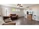 Cozy living room featuring hardwood floors, ceiling fan and three windows at 11975 Riverstone Cir # 9E, Henderson, CO 80640