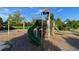 A green slide and climbing structure in the River Oaks community playground at 11975 Riverstone Cir # 9E, Henderson, CO 80640