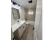 Stylish bathroom featuring modern fixtures, vanity with a white countertop, and tiled shower at 5535 Clear Creek Dr, Denver, CO 80212