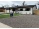 Inviting exterior of a single-story home with updated landscaping and a 'For Sale' sign at 5535 Clear Creek Dr, Denver, CO 80212