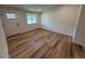 Bright living room with wood flooring, white trim, and a large window at 5535 Clear Creek Dr, Denver, CO 80212