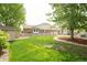 Well-maintained backyard with lush green lawn, shed, and charming stone pathway at 1510 S De Gaulle Cir, Aurora, CO 80018
