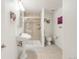 Bathroom with pedestal sink, walk-in shower with glass door and neutral tile, and modern fixtures at 1510 S De Gaulle Cir, Aurora, CO 80018